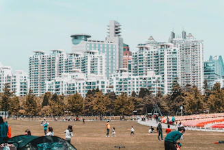 Community park area with families enjoying outdoor space near apartments
