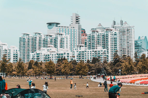 Community park area with families enjoying outdoor space near apartments