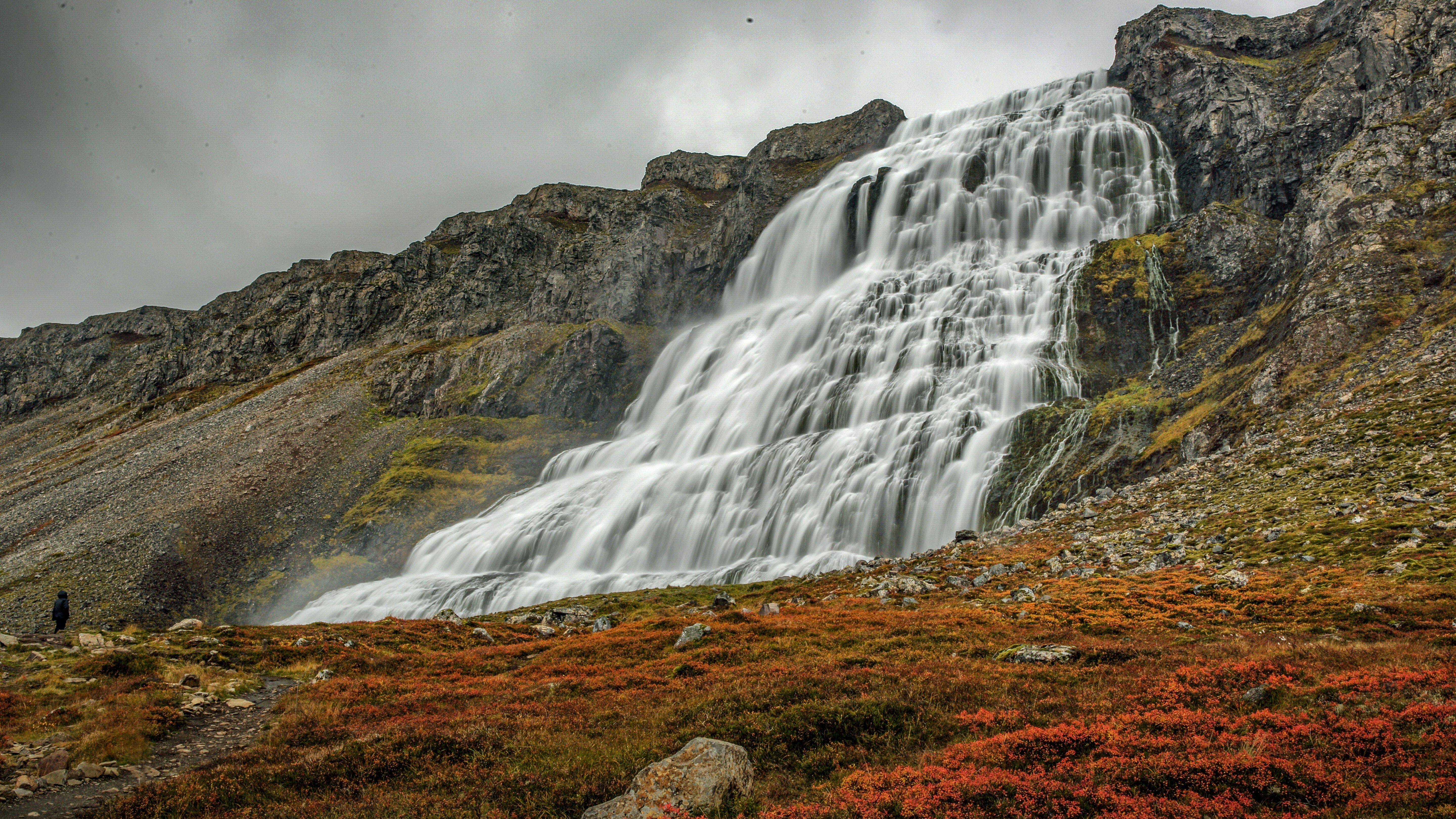 waterfalls on brown and green mountain