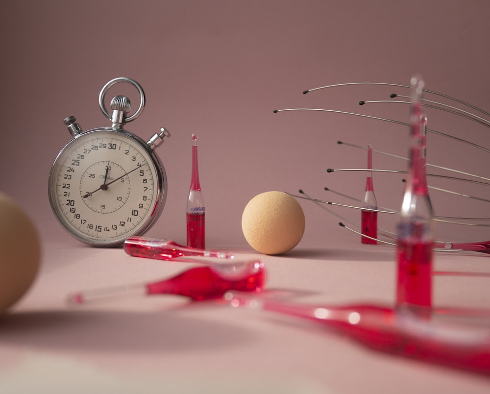 red and silver analog alarm clock