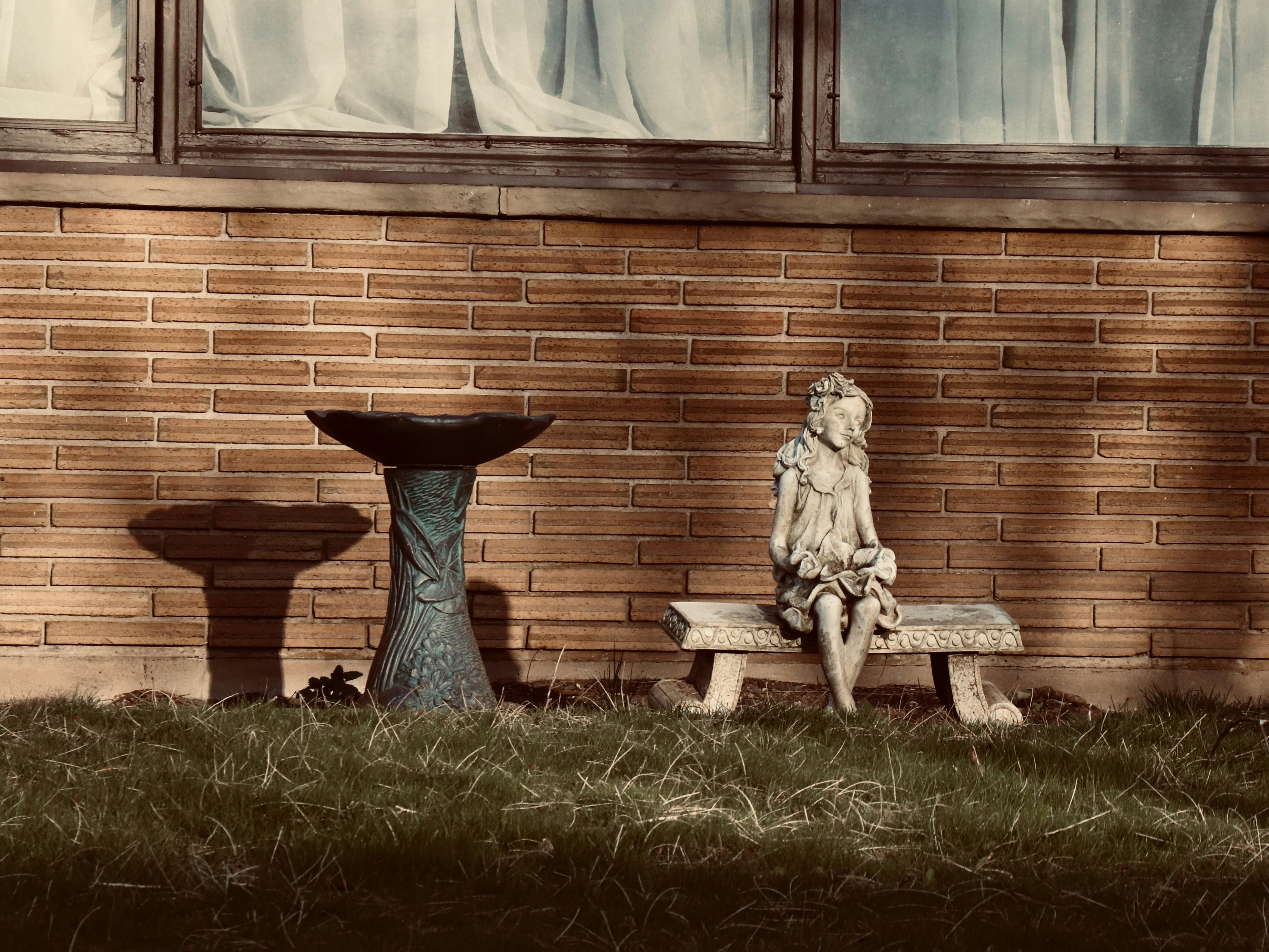 Gray concrete statue on green grass field