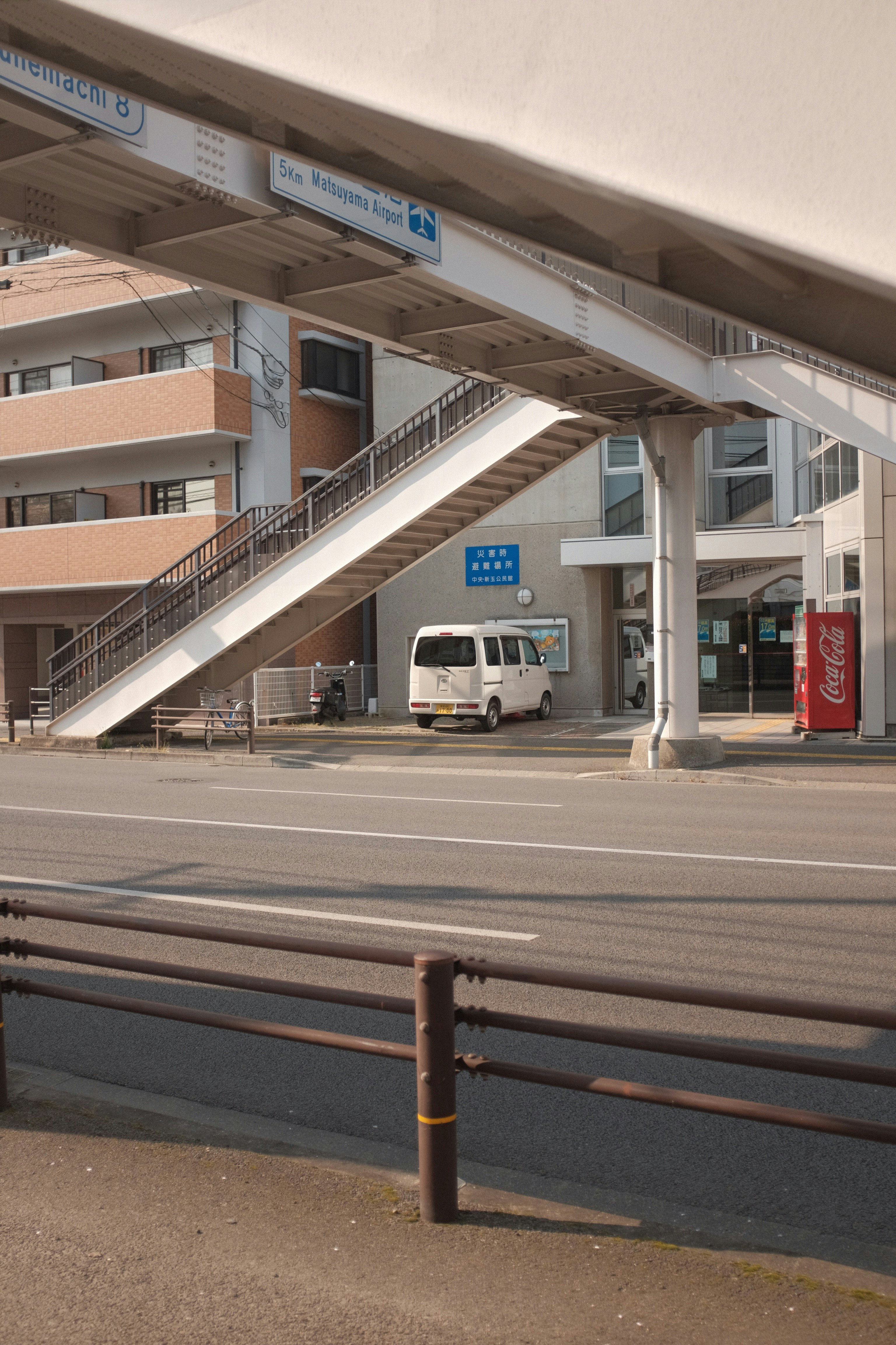 white van on road near building during daytime