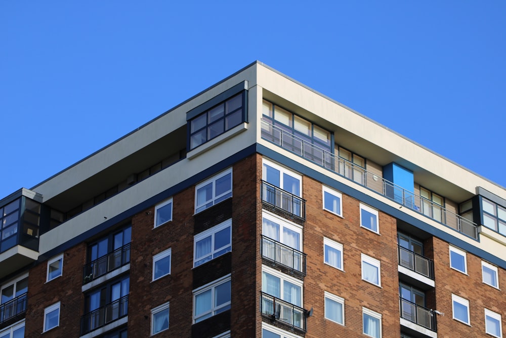 brown and white concrete building under blue sky during daytime