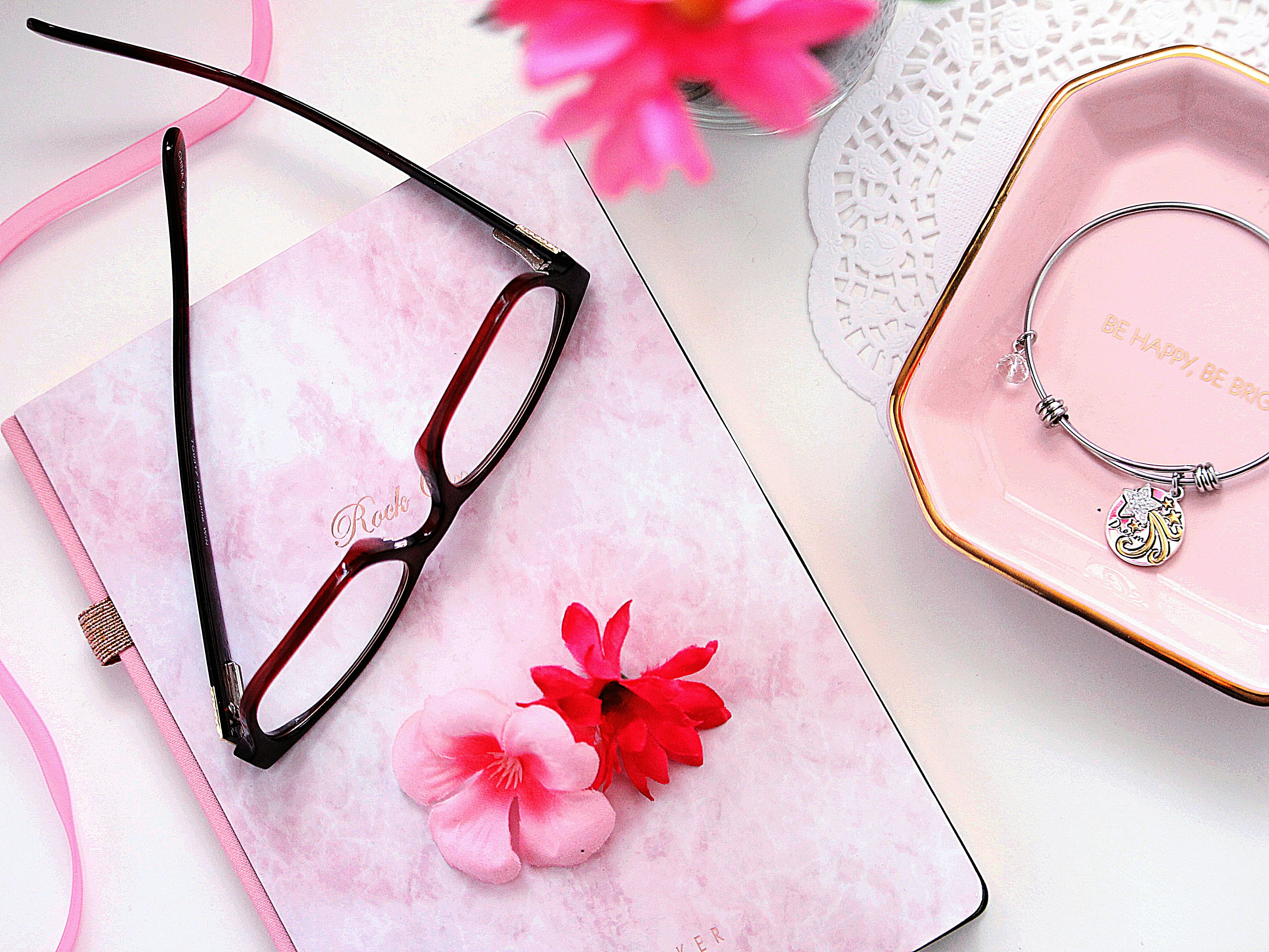 7 Affordable Ways to Update Your Accessories for a Fresh Look – black framed eyeglasses on white and pink floral textile