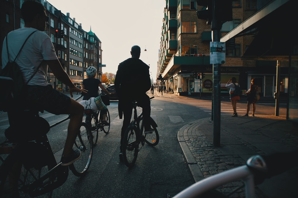 man in black jacket riding bicycle on road during daytime