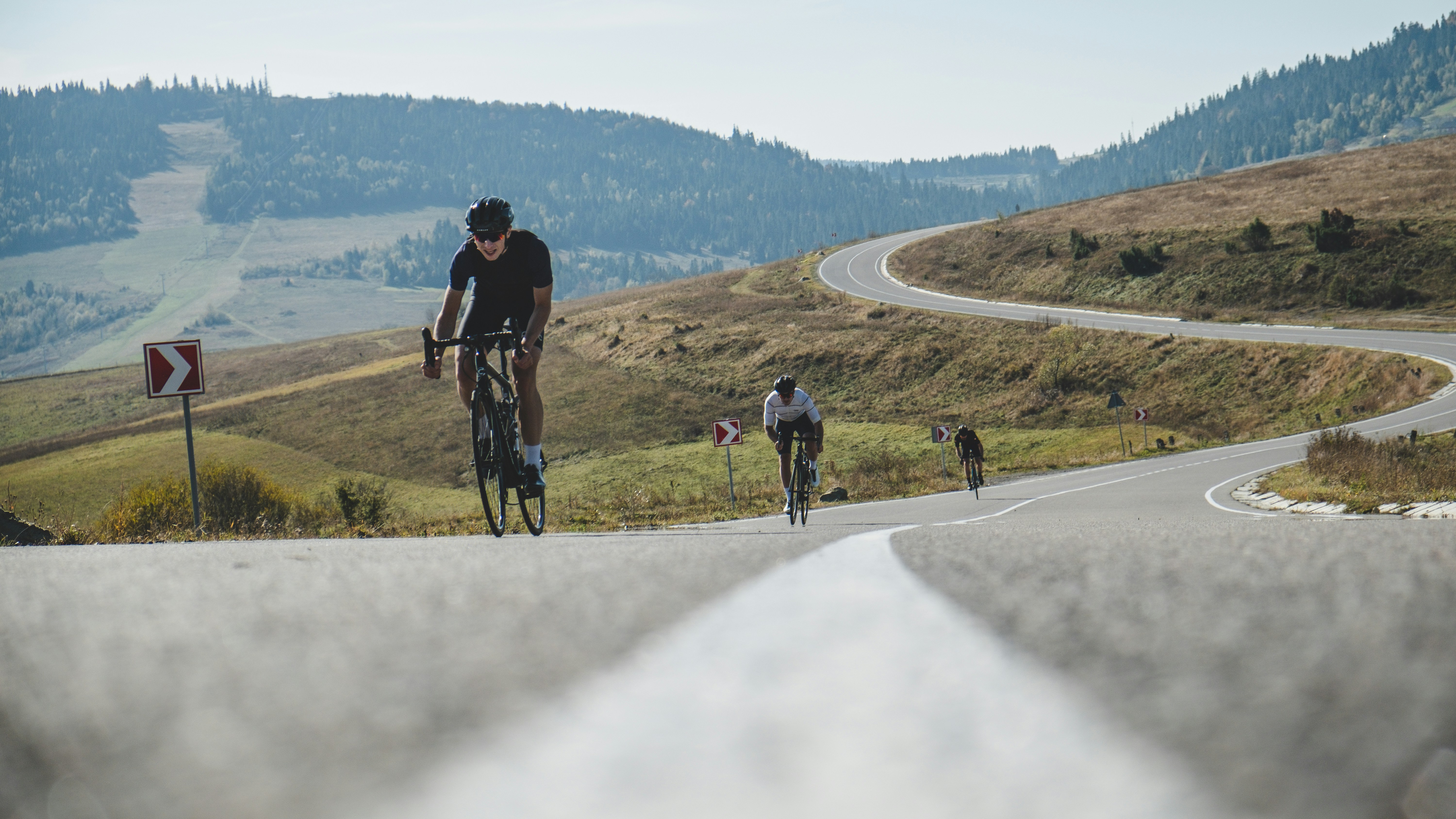 people riding bicycle on road during daytime