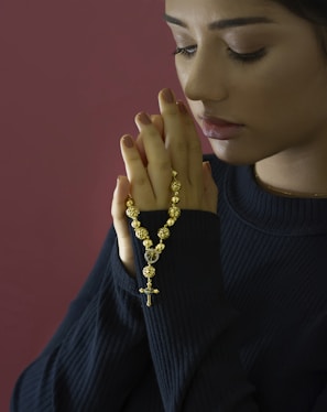 woman in black turtleneck sweater wearing gold necklace