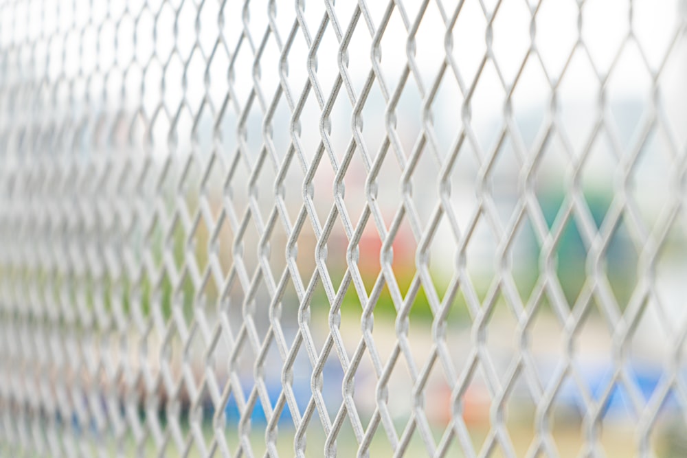 white metal fence with blue and red lines