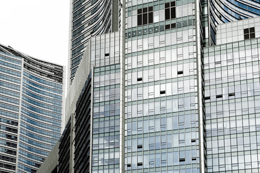 white and blue glass walled high rise building