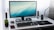 A modern computer setup featuring various tech gadgets and accessories on a sleek desk.