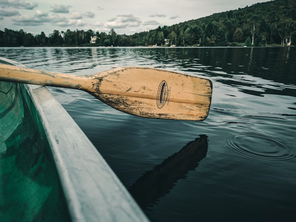 brown wooden boat on body of water during daytime