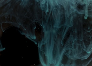 Close-up of audio waveforms pulsating in vibrant electric teal against a deep obsidian background.