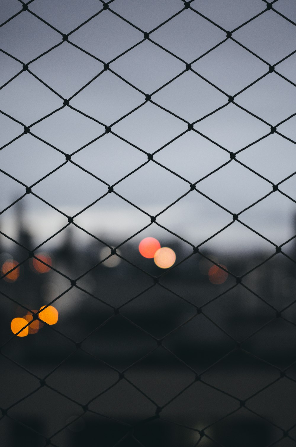 grey metal fence with orange light