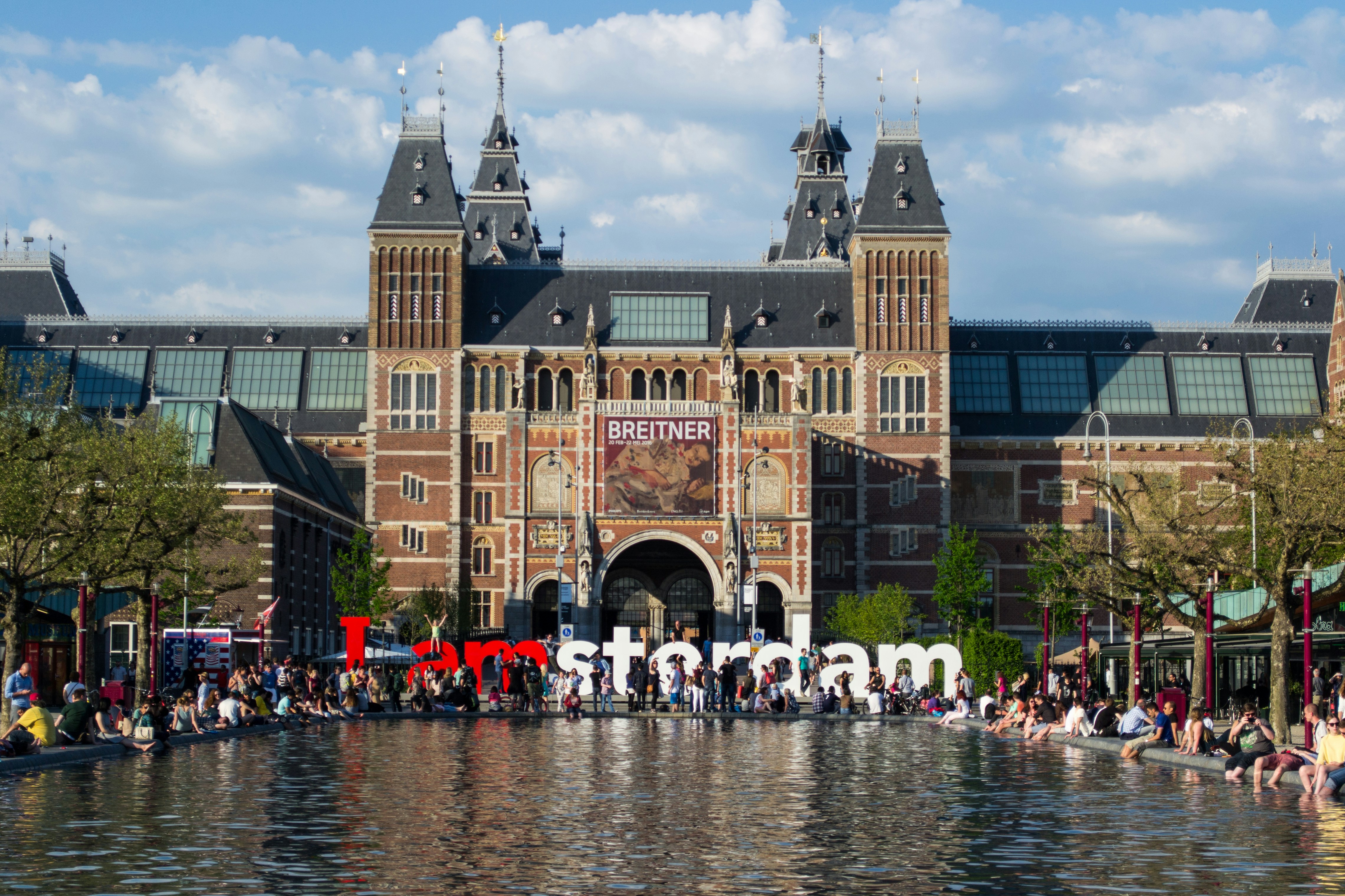 people in front of brown concrete building during daytime