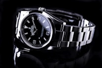 silver and black round analog watch