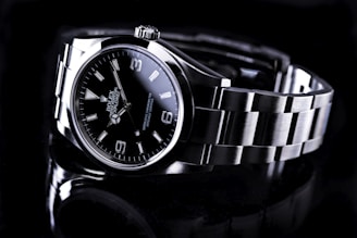 silver and black round analog watch