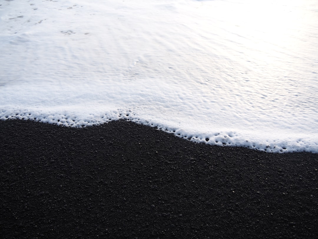 black sand with foot prints