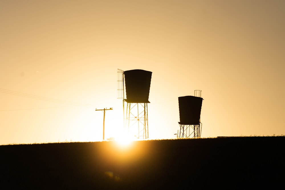 silhouette of wind turbines during sunset