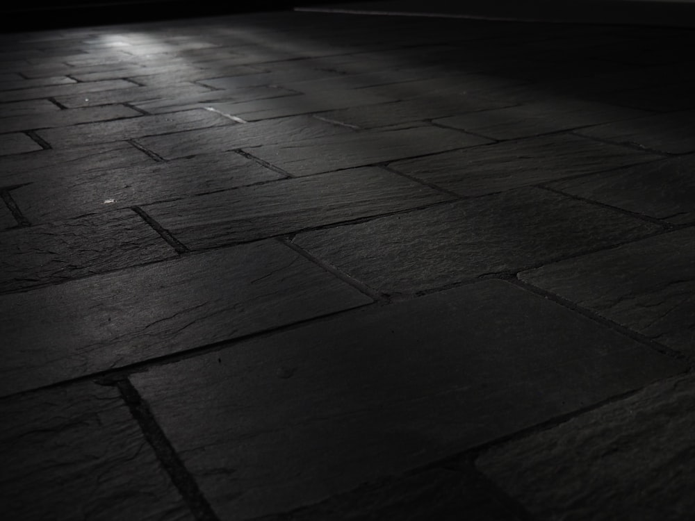 black and white photo of a brick floor