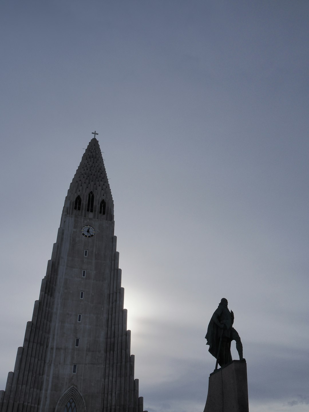 man in black jacket standing on top of building