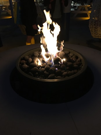 A cozy backyard evening with the large Brozero brasero glowing warmly among friends.