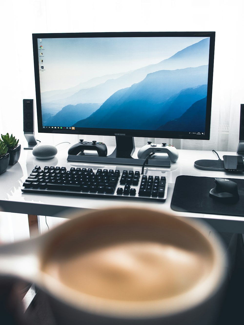 black flat screen computer monitor and black computer keyboard on white desk