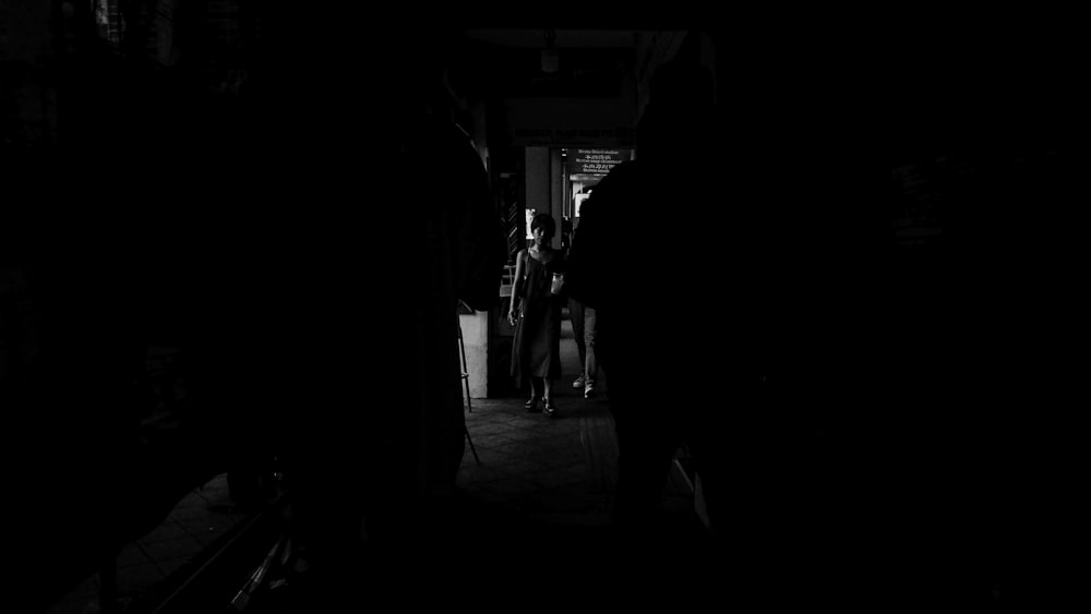 silhouette of people walking on street during night time