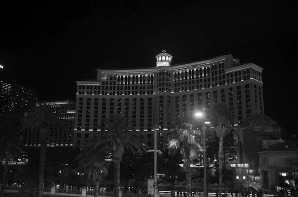Luxury hotel exterior near Haram with elegant lighting and palm trees at dusk