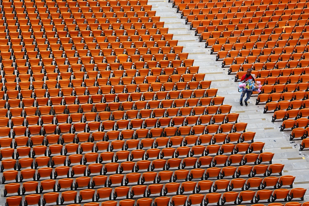 people walking on orange and white stadium