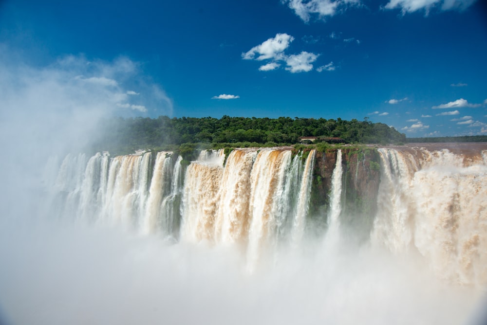 waterfalls under blue sky during daytime