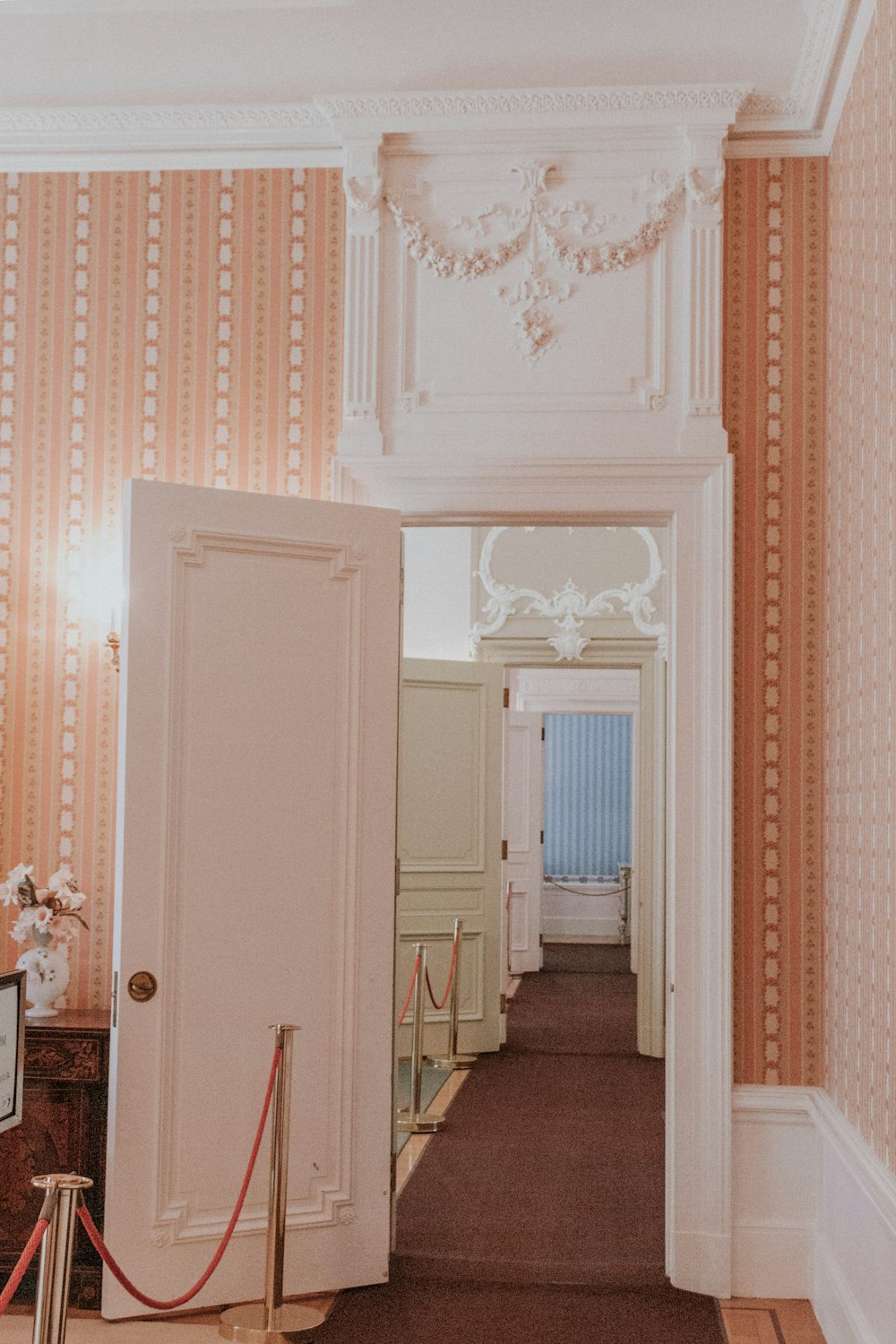 white wooden door near white wooden cabinet