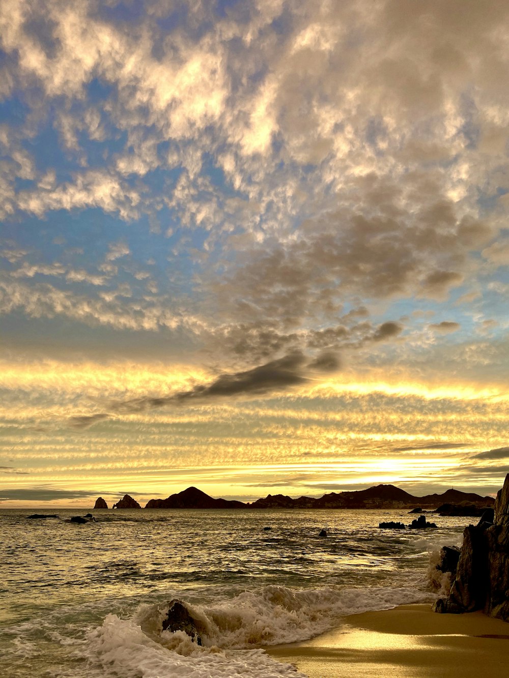 body of water under cloudy sky during sunset