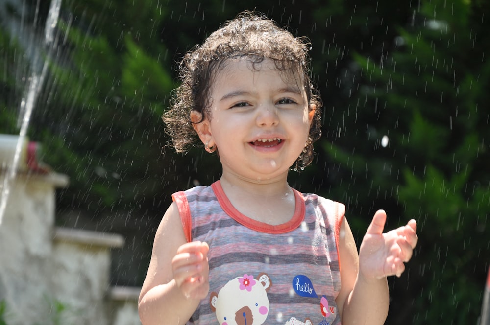 girl in white and blue tank top smiling