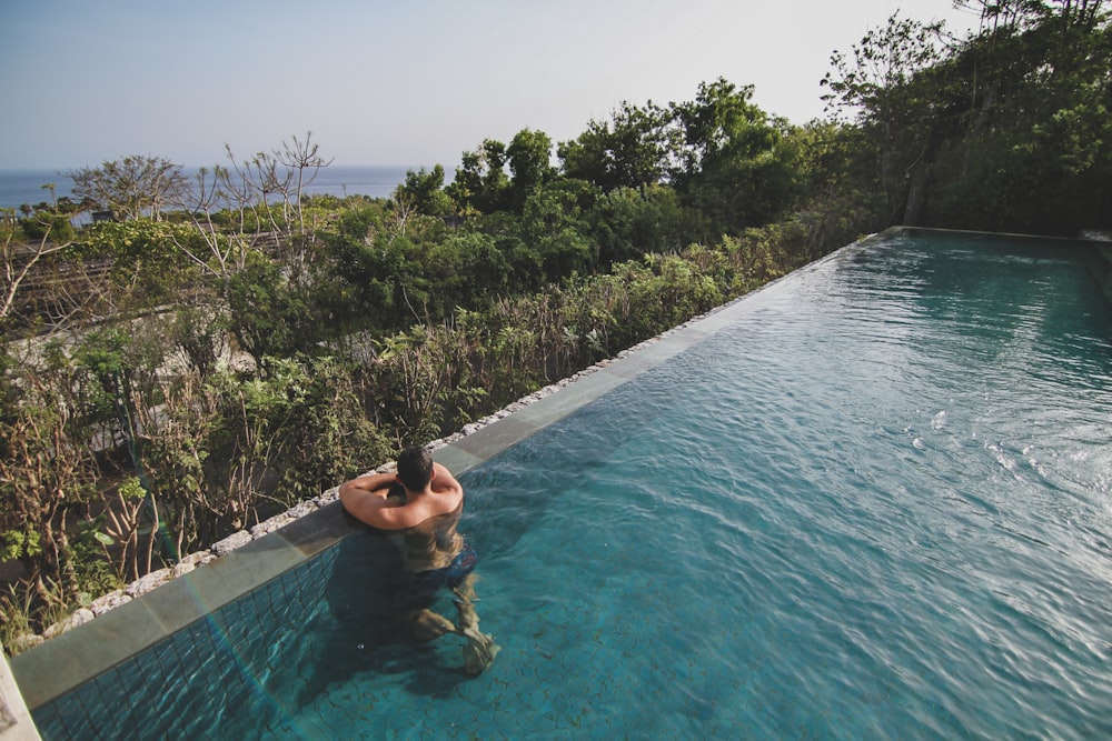 man in swimming pool during daytime