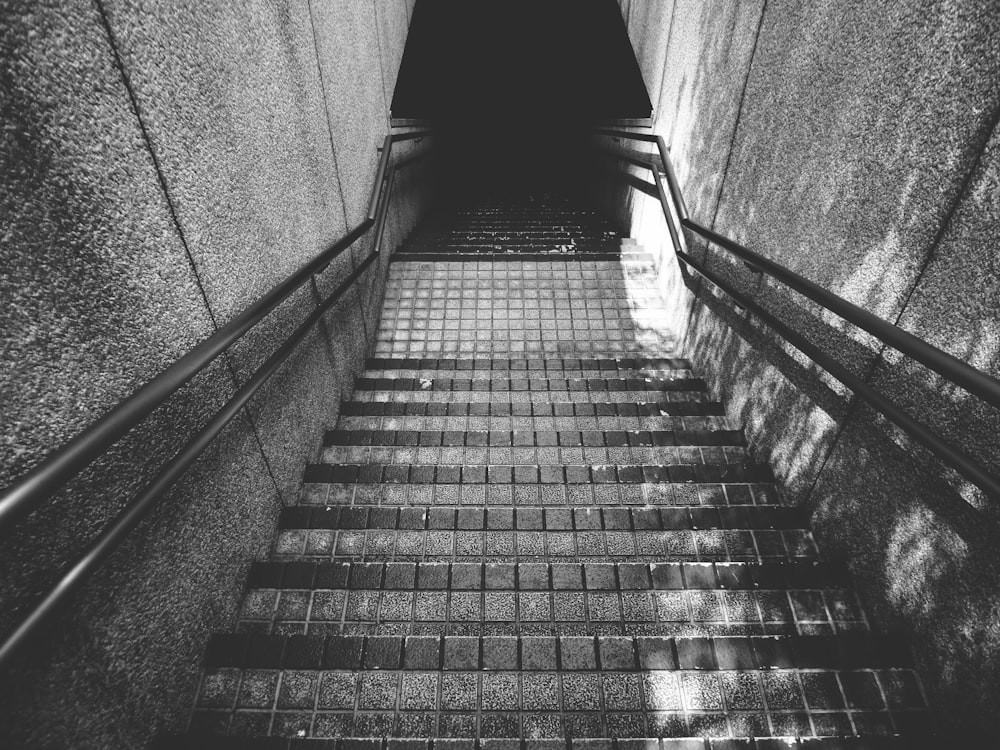 grayscale photo of staircase with railings