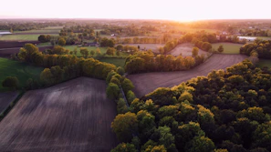 Aerial view of a premium plot with clear boundaries under a golden sunset.