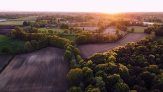 Aerial view of a premium plot with clear boundaries under a golden sunset.