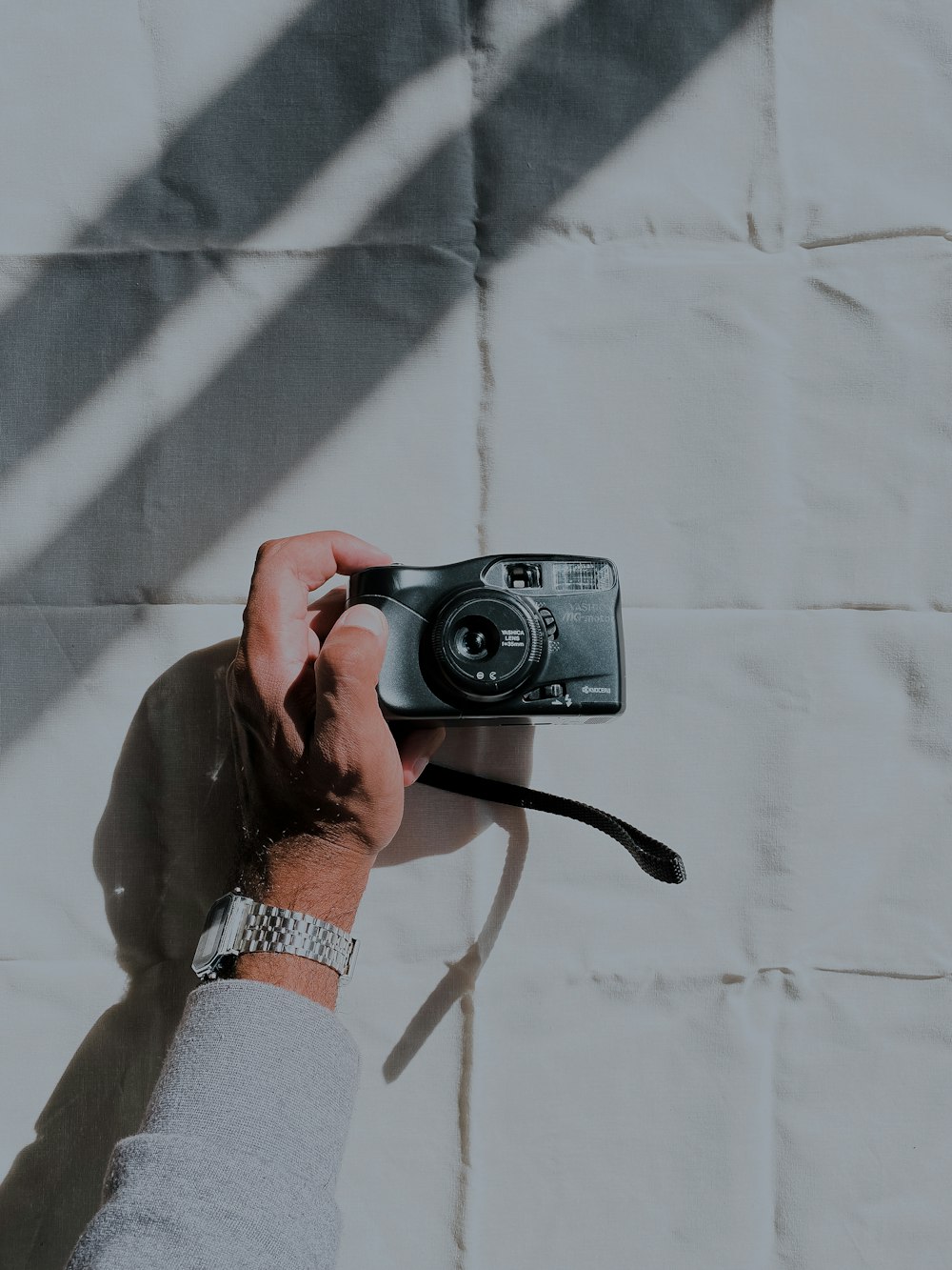 person holding black dslr camera