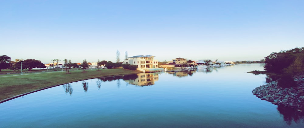 white and brown concrete building near body of water during daytime