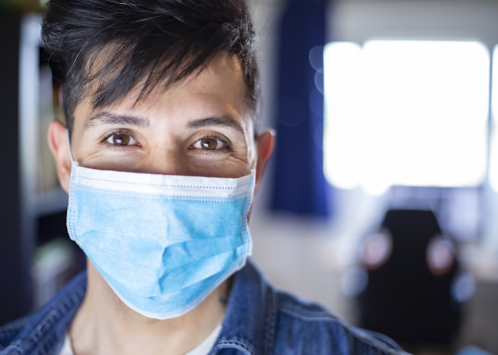 woman in blue denim jacket with white face mask