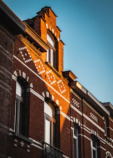 Completed brick façade renovation on a traditional Bremen townhouse in bright daylight