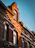 Close-up of a beautifully restored red brick facade glowing under soft sunlight.