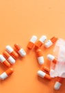 orange and white medication pill