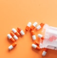 orange and white medication pill