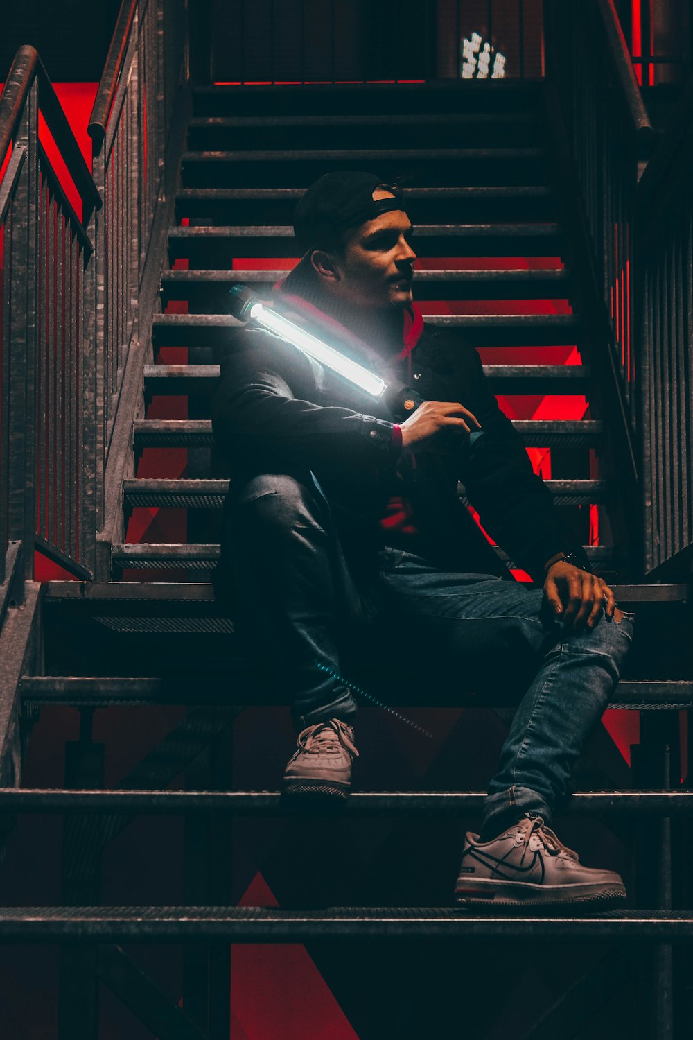 man in black suit sitting on stairs