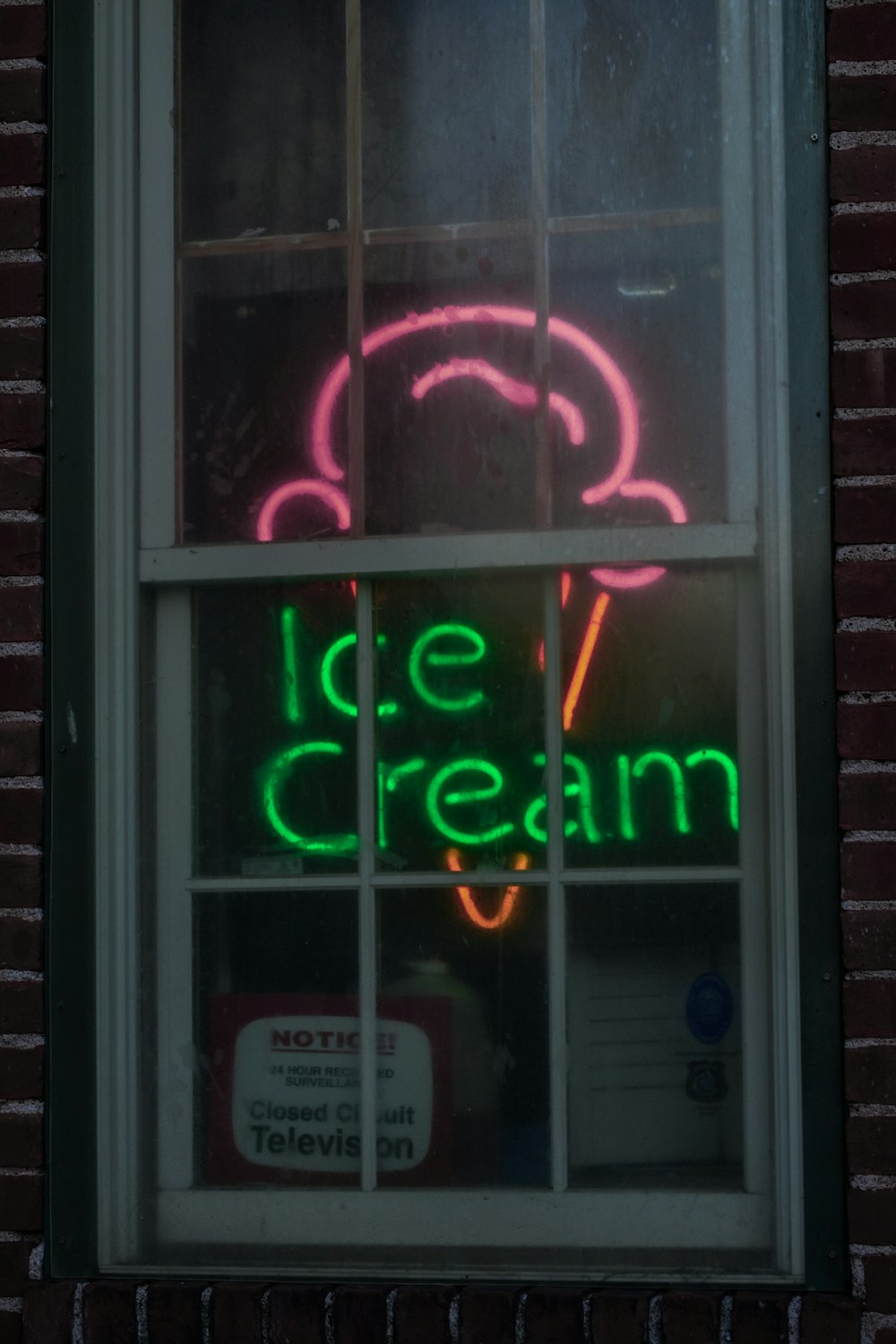 a neon sign in the window of a building