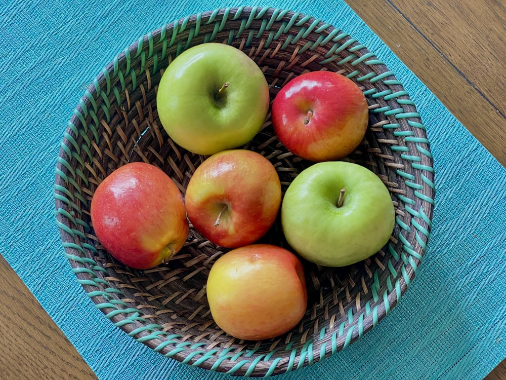 green apple and orange fruits on blue and white round plate