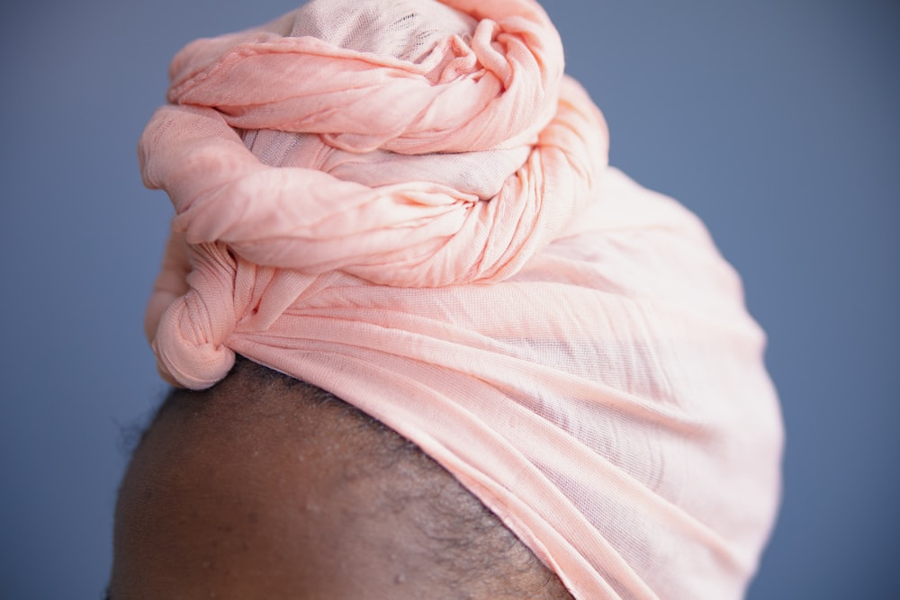 person in white shirt with white textile on lap