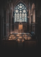 Candles lit in a quiet chapel, casting warm light