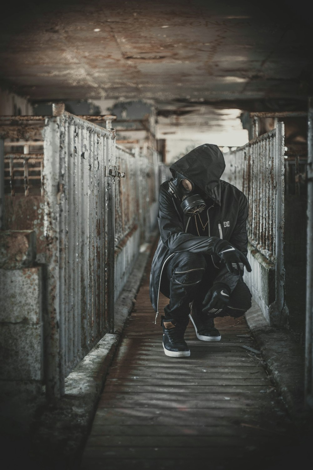 a man in a gas mask crouches down